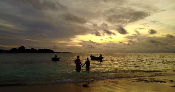 Beautiful man and woman on romantic honeymoon spend quality time on beach on clean white sand 4K bac