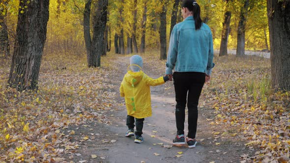 Cute Little Boy and Mother During the Walk in Nature