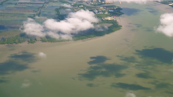 A view of the upper plane window while floating in the air, overlooking the mountains and natural wa