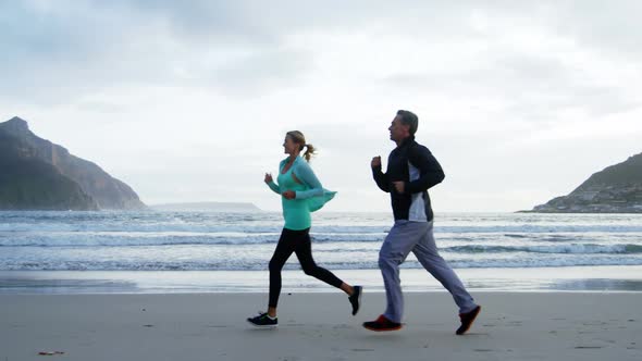 Mature couple jogging on beach