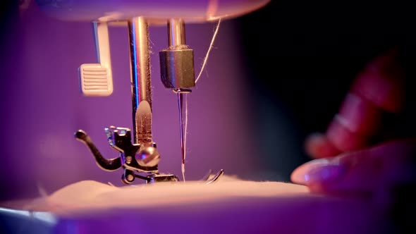 Hand of Seamstress Puts a Cloth Under the Needle - Sewing Process