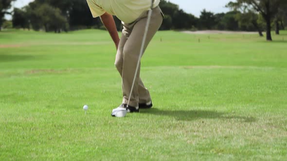 Mature man playing golf on golf course