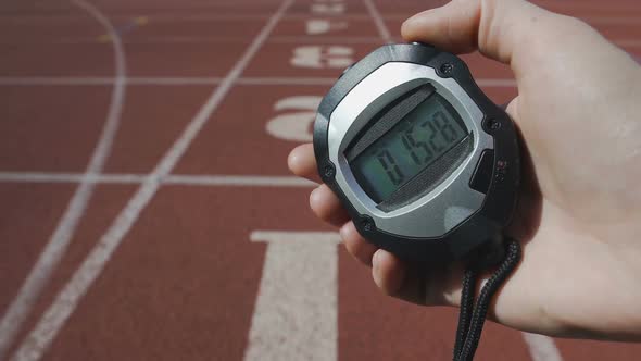Hand of Referee Fixing Time on Stopwatch at Running Competition, Sport Challenge