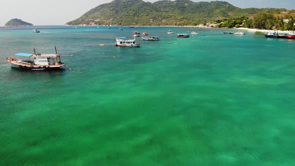 Boats in Calm Sea in Port. Drone View of Fishing and Dive Boats Floating on Tranquil Surface