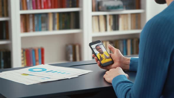 Young teacher communicating by videoconferenceat home office. Young man telling a project