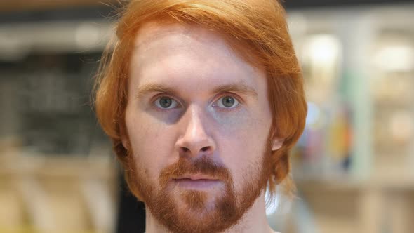 Serious Redhead Beard Man Looking at Camera