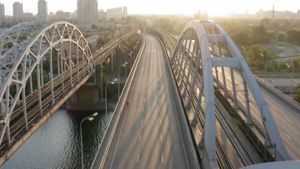 Aerial drone view of cyclist riding over the bridge