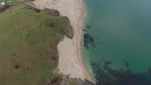 Wild sandy beach surrounded by picturesque rocks