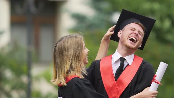 Young Funny Male and Female Graduates Laughing, Celebrating Graduation, Success