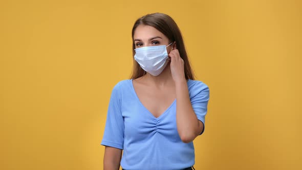 Portrait Happy Healthy Woman Taking Off Medical Face Mask Breathing Freedom Posing Isolated Orange