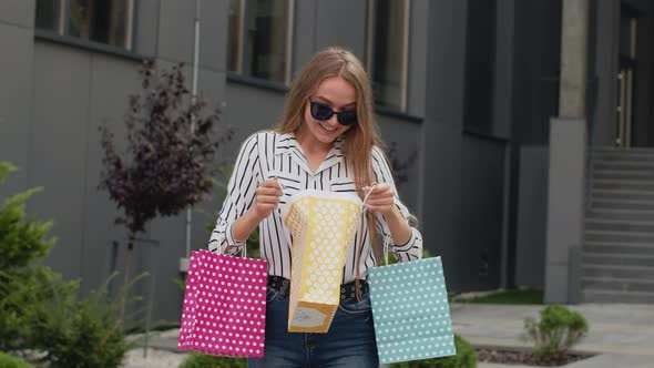 Teenager Girl in Trendy Clothes with Multicolor Shopping Bags. Black Friday Sale Discounts Concept