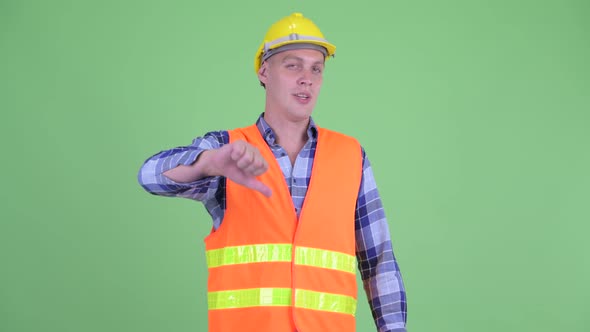Sad Young Man Construction Worker Giving Thumbs Down