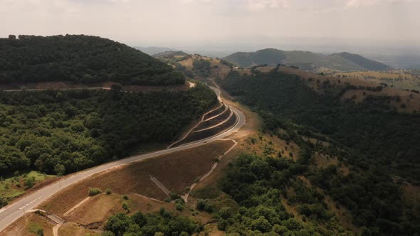 Car Enters Tunnel Aerial Top View Drone Above Greece Daytime Summer  Footage