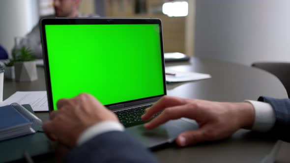 Business Man Using Touchpad Laptop Green Screen on Corporate Team Conference