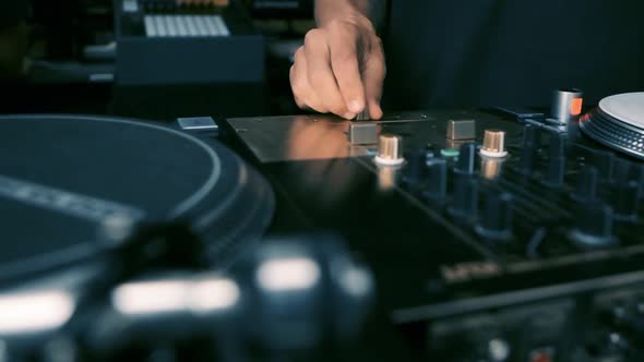 Disc jockey scratching vinyl record on analog turntable