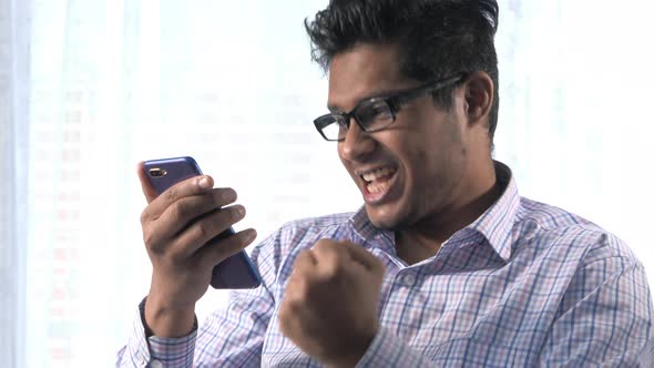  Happy Businessman Using Smart Phone Indoor 