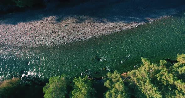 Low Altitude Flight Over Fresh Fast Mountain River with Rocks at Sunny Summer Morning.