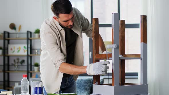 Man Painting Old Table in Grey Color at Home