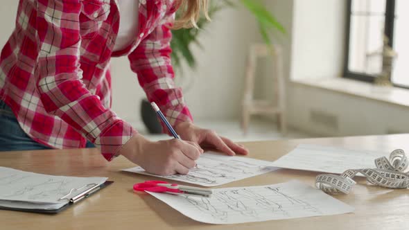 Closeup Woman Fashion Designer Hand Working in Office Workshop