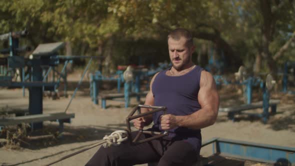 Man Making Low Cable Pulley Row Seated Outdoors