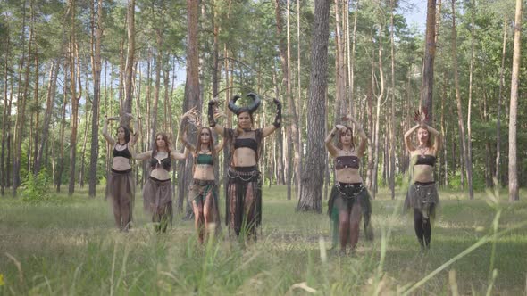 Group of Women Dancers with Make-up and in Mystical Fabulous Costumes Dancing Groovy Dance in Nature