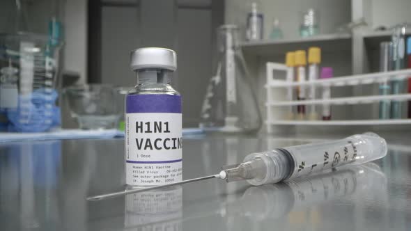 H1N1 vaccine and syringe in medical lab