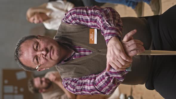 Senior Man Posing for Camera at Mental Support Group Meeting