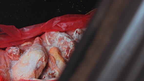 The Worker Puts the Box of Frozen Meat in the Trunk of the Car