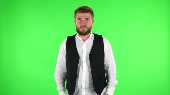 Confident Man Smiling While Looking at Camera. Green Screen