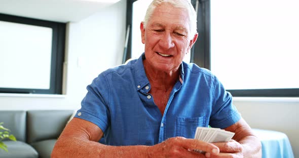 Retired man playing with cards