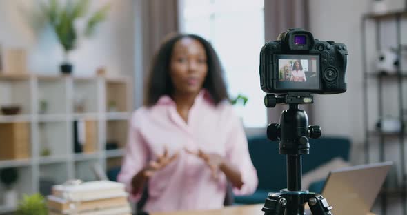 African American Woman Recording Video for Her Internet Followers from Cozy Home Studio