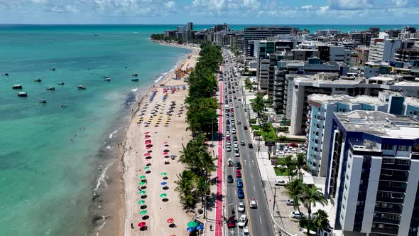 Aerial panning shot of turquoise water beach at Maceio Alagoas Brazil.