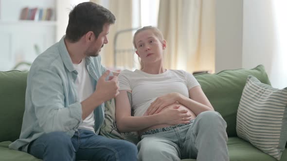 Husband Having Argument with Upset Pregnant Wife at Home