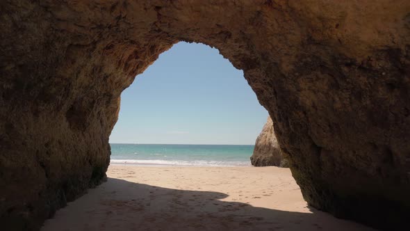 Moving Forward Stabilized Exit From the Cave to the Sea with Waves Beach for Tourists in Summer