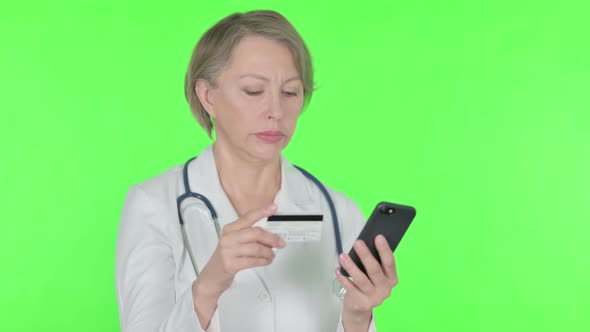 Online Shopping on Smartphone By Old Female Doctor on Green Background