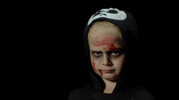 Halloween, Angry Girl with Blood Makeup on Face. Kid Dressed As Scary Skeleton, Posing, Making Faces