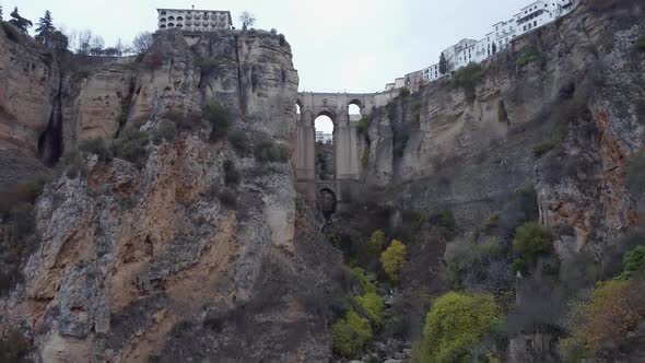 Retreating aerial reveals Guadalevin River gorge splitting Ronda Spain