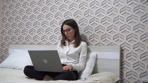 Woman Greets and Talks with Colleagues at Video Chat Using Laptop