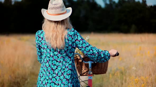 Carefree Woman In Hat Enjoying Weekend.Woman Cyclist Walking With Bike On Holiday Vacation Trip.