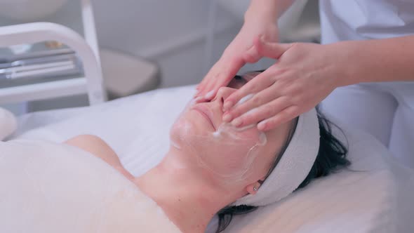 Cosmetologist Performs the Procedure of Cleansing and Moisturizing the Skin