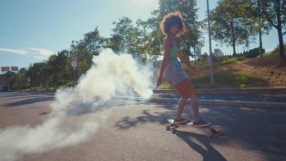 Beautiful young woman cruising around the city with her longboard.