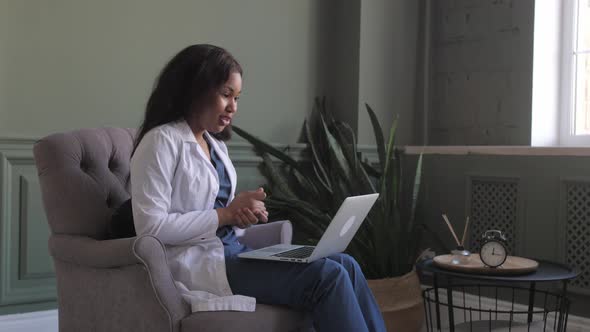 African American Doctor Woman Conducts Videoconference with Patient