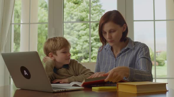 30s Mother Helping Her Son with Online Homework