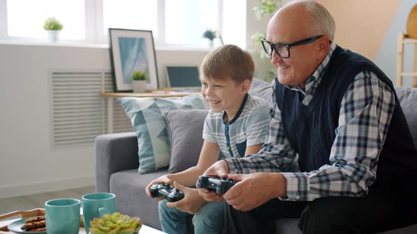 Joyful People Old Man and Child Playing Video Game Talking Having Fun in Apartment alt