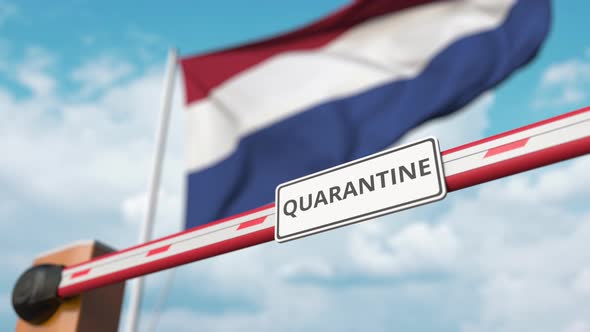 Opening Barrier with QUARANTINE Sign Against Flag of Netherlands