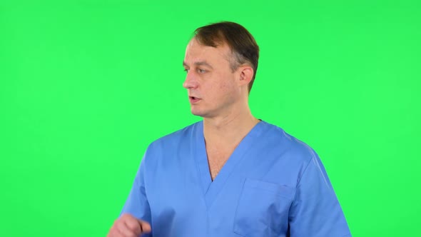 Medical Man Talking and Pointing Side Hand for Something, Copy Space. Green Screen