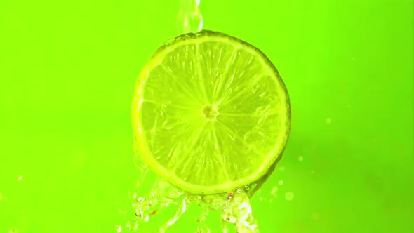 Super Slow Motion with a Piece of Juicy Lime Draining Water