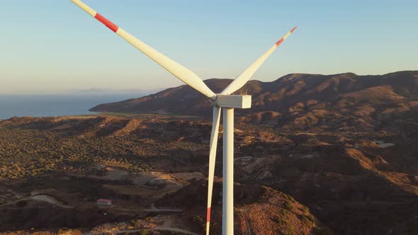 Wind Turbines with Blades in Wind Farm Aerial View Bright Orange Sunset