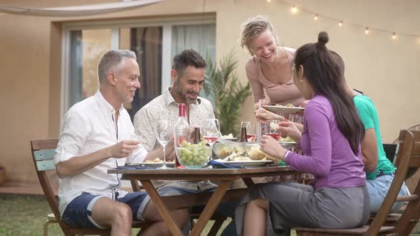 Happy Friends Having Fun Sharing Healthy Dinner Meal at Home Garden Friendship Food Gathering and