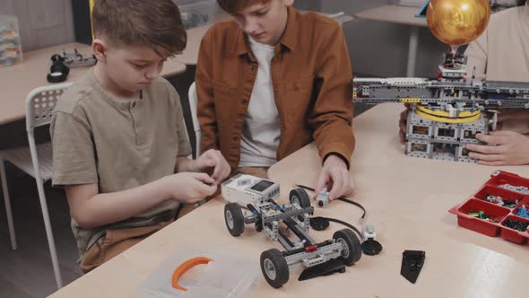 Boys Building Robot Car